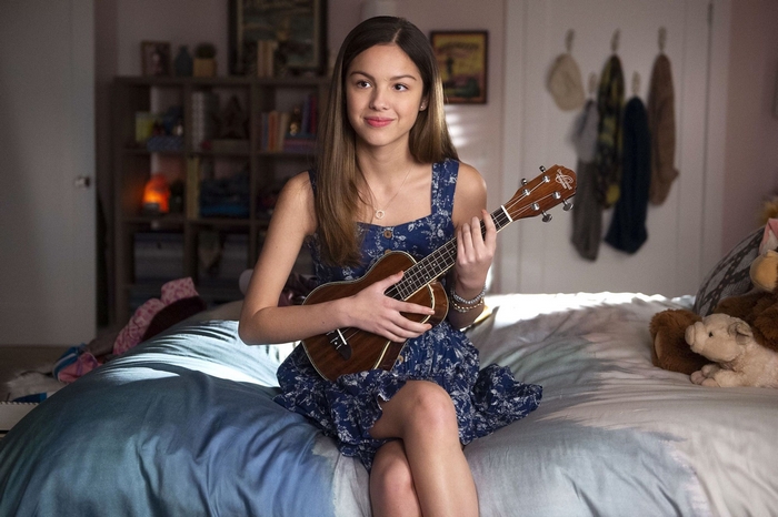 Olivia Rodrigo plays ukulele in a bedroom
