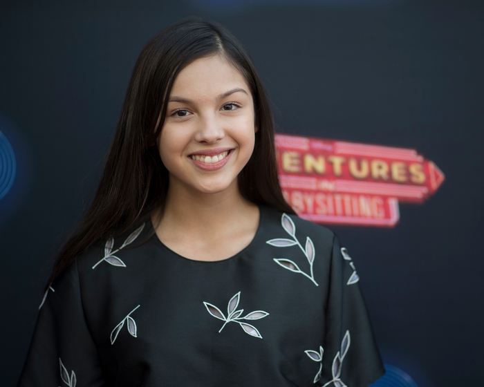 Olivia Rodrigo smiles at an event