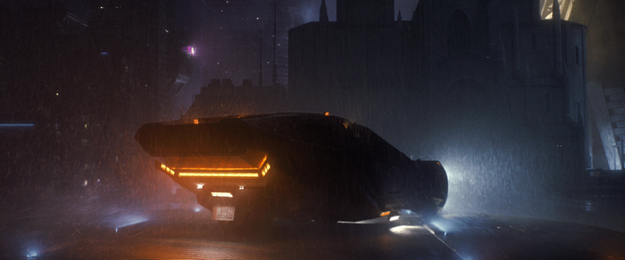 Vehicle in futuristic city during rain at night