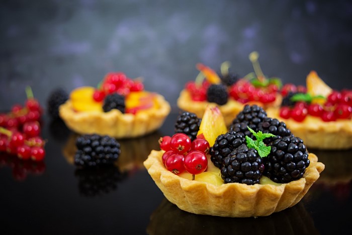 Fruit tarts with berries and peaches