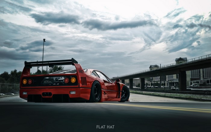 Red Ferrari F-40 sports car on a road