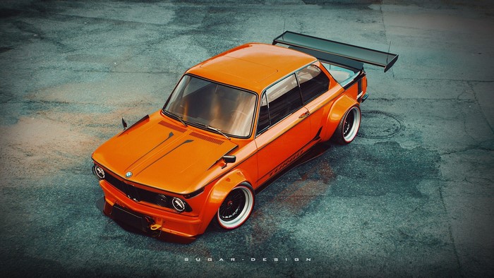 Orange BMW 02 Series with a large rear spoiler