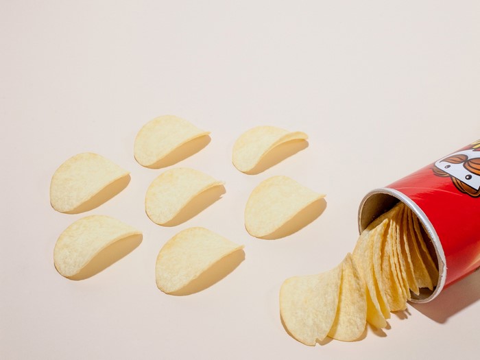 Pringles chips spilling out of a can