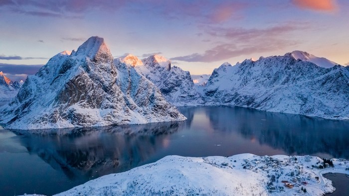 Snow-covered mountains and a bay in Reine, Norway