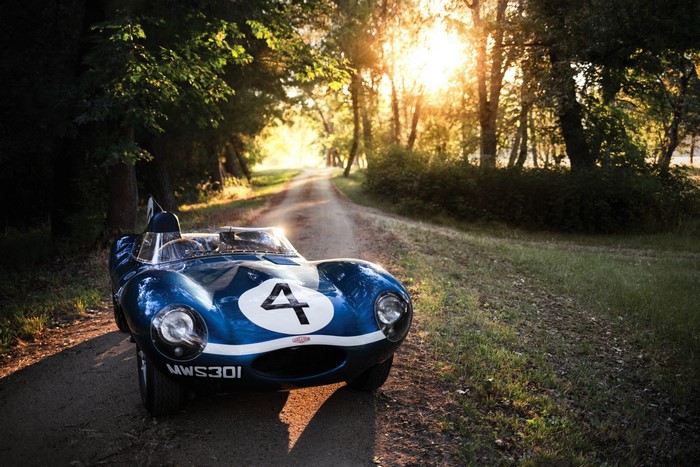 Blue Jaguar race car with number 4 on a dirt road