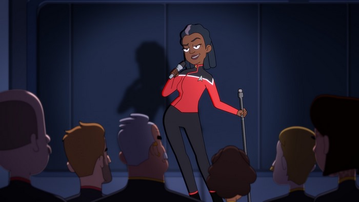 Captain Carol Freeman singing on stage