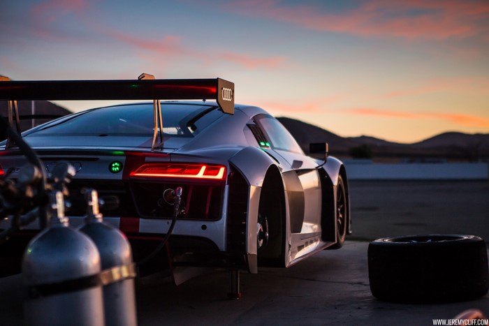 Audi R8 LMS race car at sunset with fuel tanks