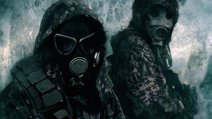 Two soldiers wearing gas masks and camouflage