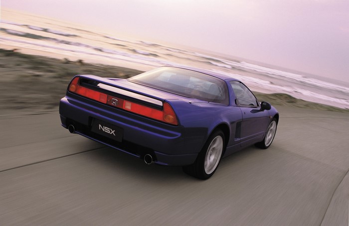 Blue Honda NSX mk1 driving on a coastal road