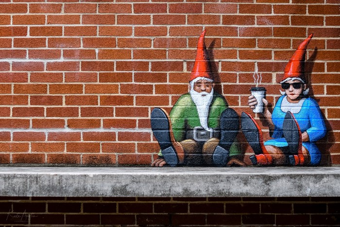 Gnomes with coffee cups on a brick wall in Fayetteville, NC
