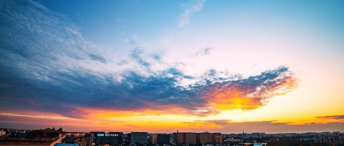 Cityscape at sunset with dramatic clouds