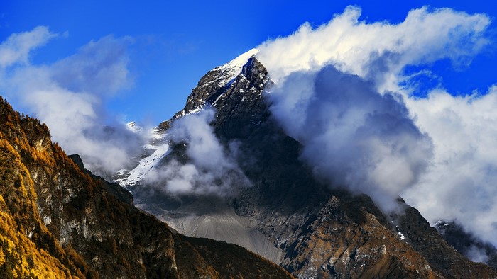 Snow-capped mountain peak shrouded in clouds