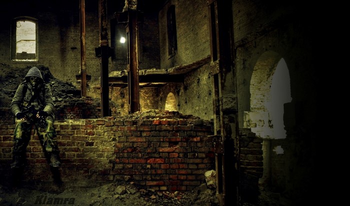 Man in gas mask and camouflage in abandoned building