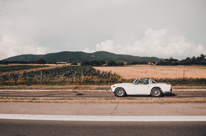 White convertible car on a rural road