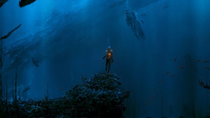 Diver in deep blue ocean with fish and wreckage