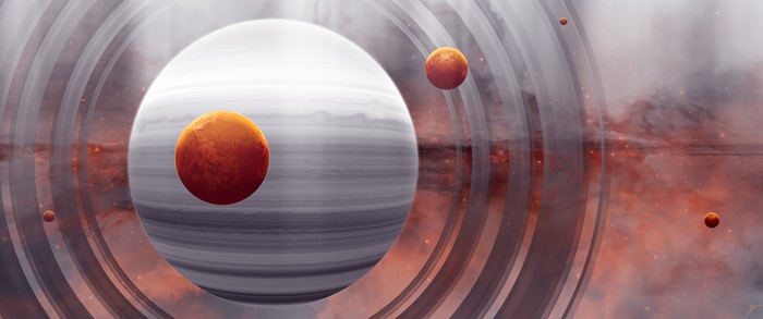 Gas giant with rings and moons in nebula