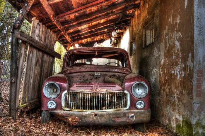 Abandoned rusty car in a shed in Poland