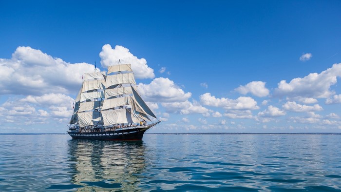 Sailing ship on the sea under a cloudy sky