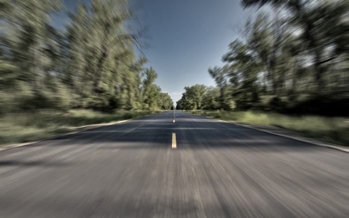 Road with trees and blue sky