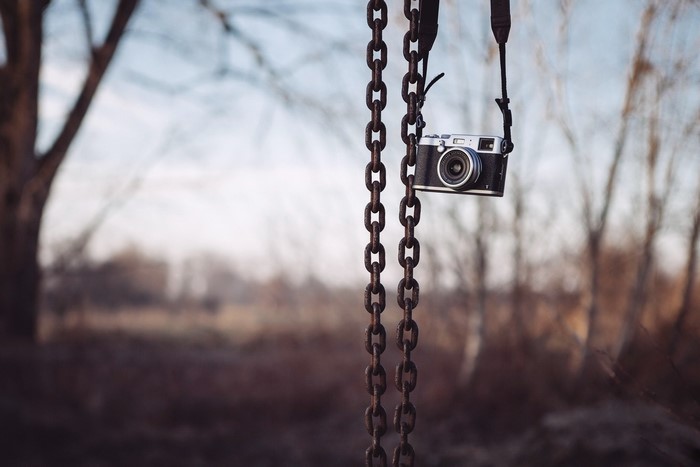 Camera hanging on chains outdoors