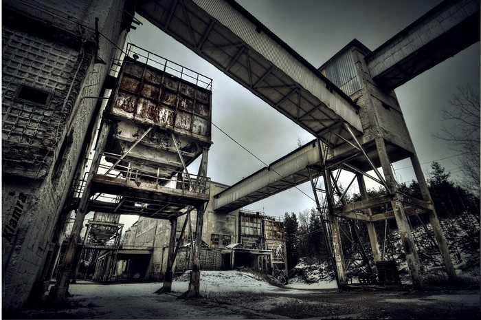 Abandoned factory complex with industrial walkways