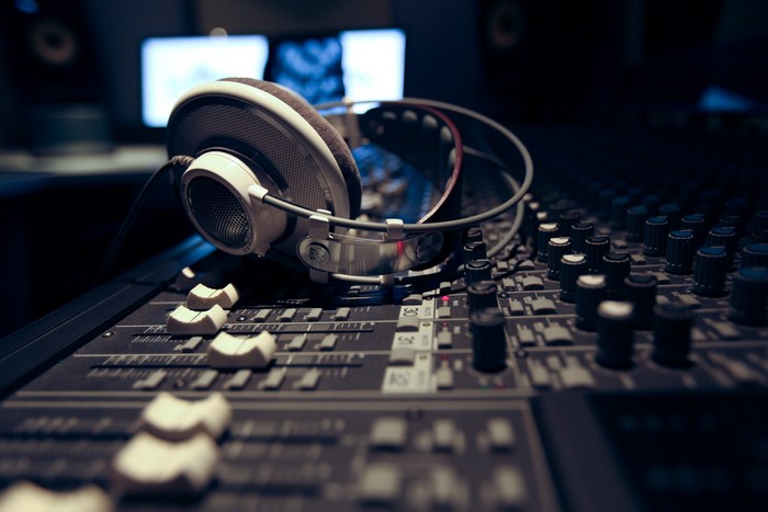 Headphones on a sound mixing console in a studio