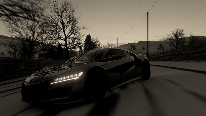 Black sports car driving on a road in Forza Horizon 4