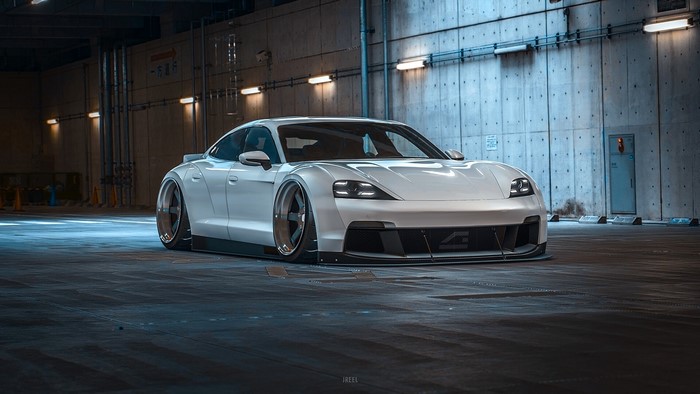 White Porsche Taycan with custom body kit in parking garage
