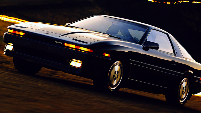 Black Toyota Supra MK3 with pop-up headlights