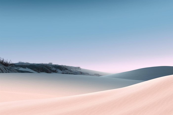 Desert sand dunes under a clear sky