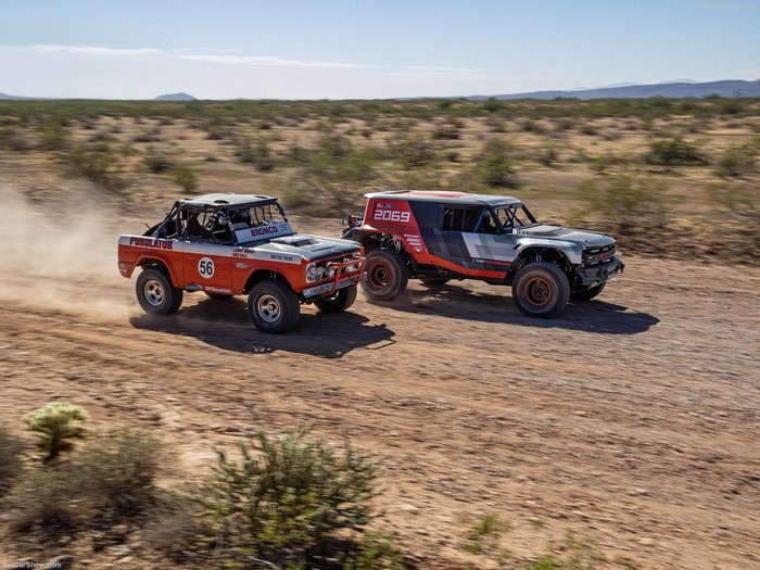 Ford Bronco off-road race trucks on a desert road