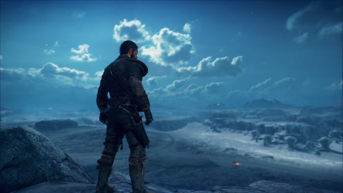 Max Rockatansky from Mad Max standing on a rock overlooking a wasteland