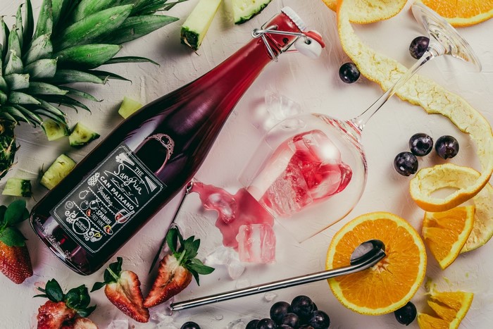 Sangria bottle with fruits and wine glass