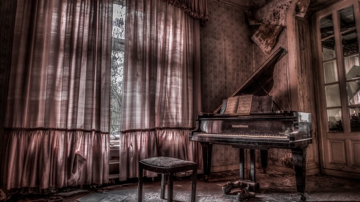 Abandoned room with piano and curtains