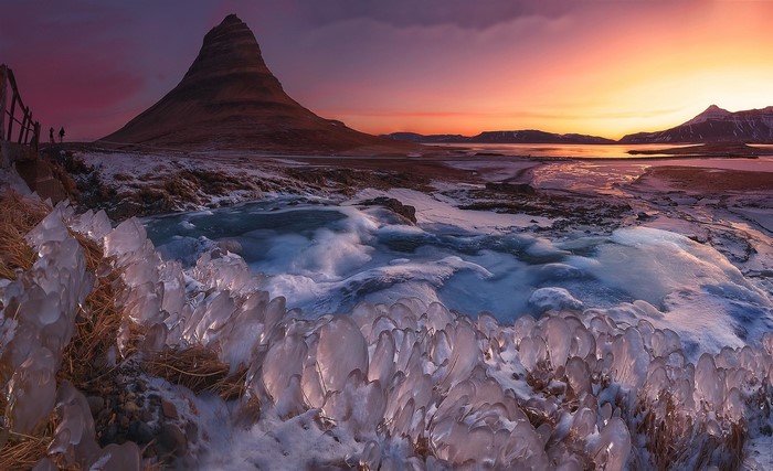Kirkjufell mountain Iceland at sunset with ice formations