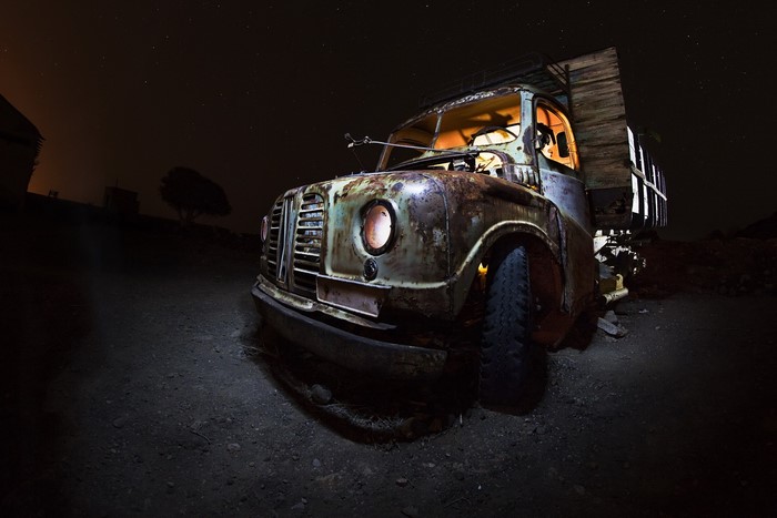 Old rusty truck at night