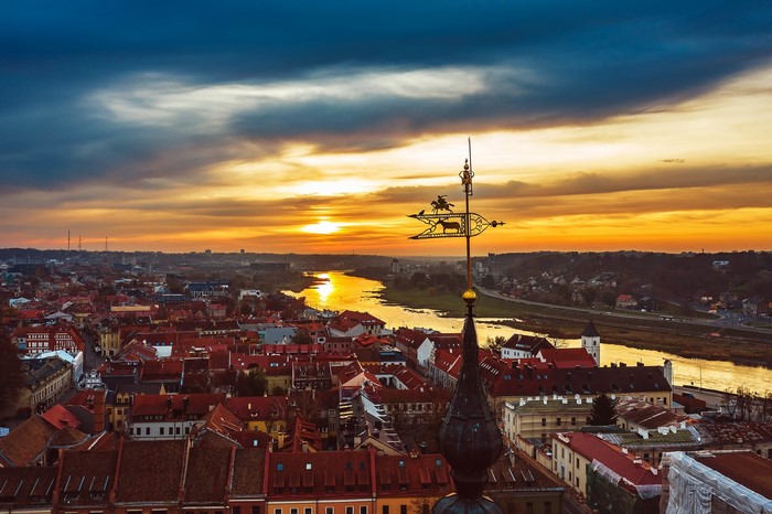 Kaunas cityscape at sunset with river and weather vane