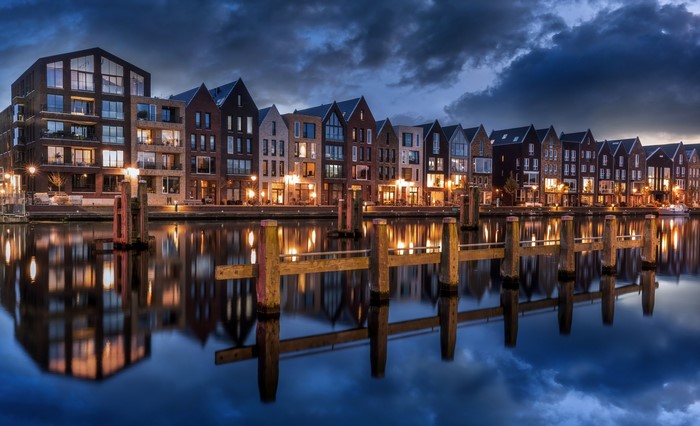 Buildings reflected in water at dusk in the Netherlands