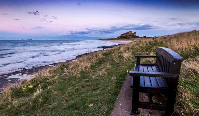 Bench overlooking Bamburgh Castle and the sea in England