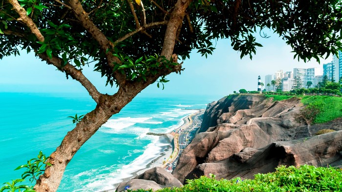 Coastal Cliffs with Lighthouse and Cityscape in Peru