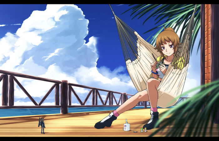 Girl in hammock on a wooden deck by the ocean