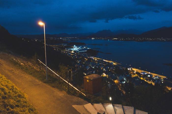 Ålesund, Norway at night with fjord and mountains