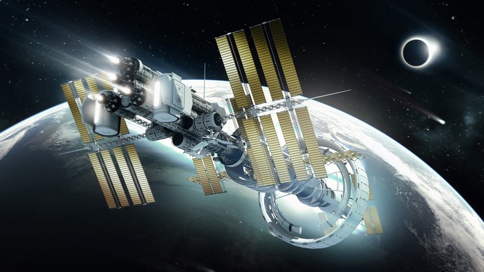 Futuristic space station orbiting a planet during an eclipse