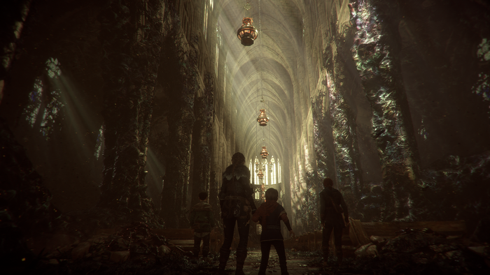 Amicia and companions in a ruined cathedral in A Plague Tale Innocence