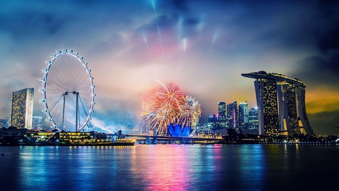 Singapore skyline with fireworks and Ferris wheel