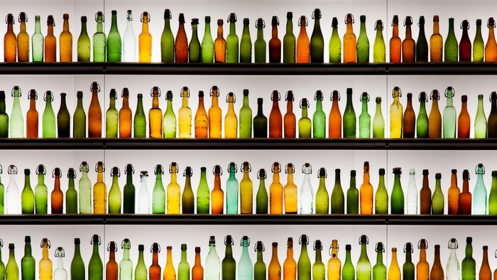 Rows of colorful glass bottles on shelves