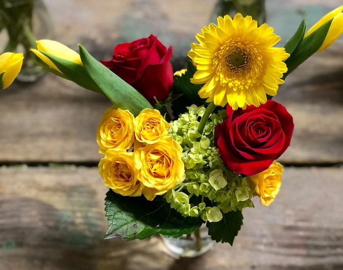 Colorful flower arrangement on a wooden surface