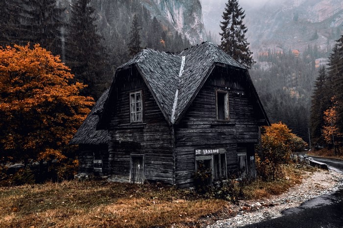 Abandoned wooden house in autumn mountains