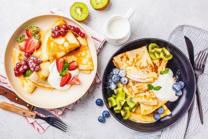 Crepes with strawberries, blueberries, kiwi, and red currants