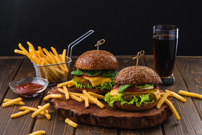 Two veggie burgers with fries and ketchup